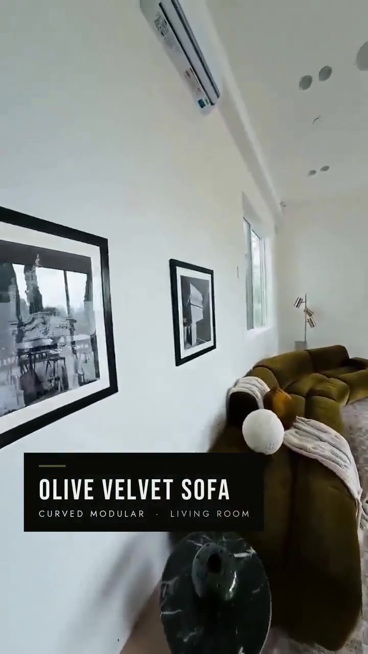 Staged Los Angeles living room with an olive velvet sofa, framed artwork and a large abstract canvas, by Nesting Dolls Design