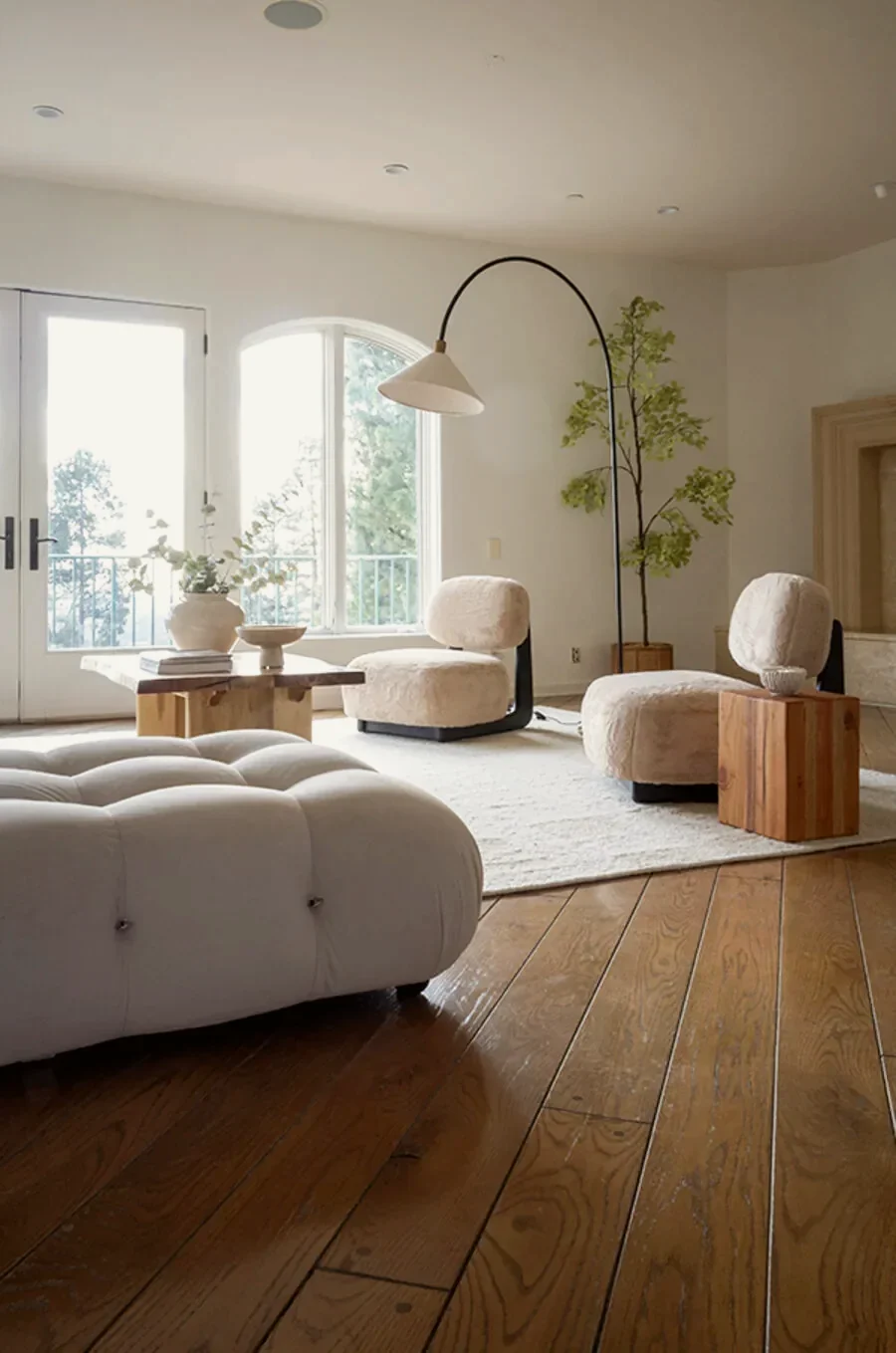 Beverly Hills living room layered with textured upholstery, warm woods and vintage ceramics, staged by Nesting Dolls Design