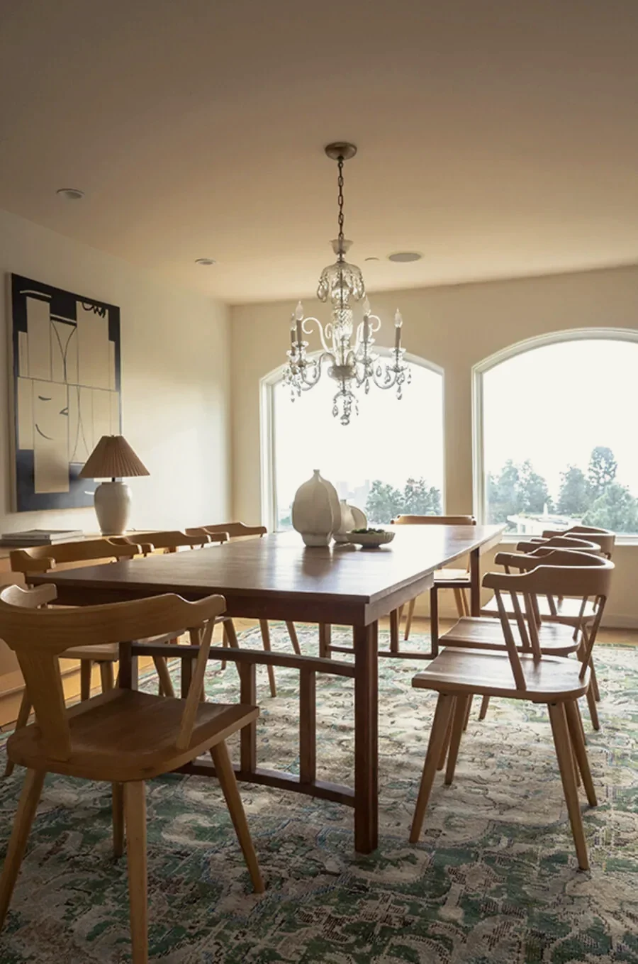 Beverly Hills dining room with a walnut table, wishbone chairs and a bold abstract canvas on the left wall, staged by Nesting Dolls Design